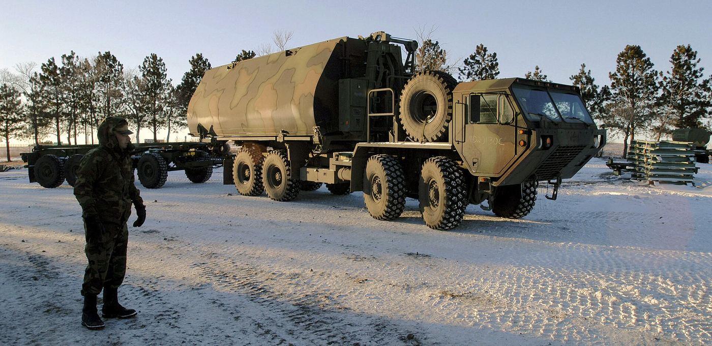 Heavy military-pattern transport truck on a hard standing.
